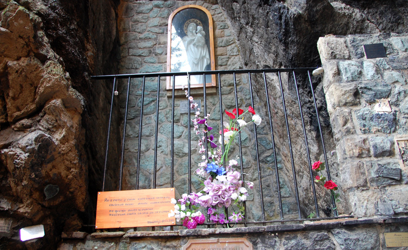 The virgin stands at the top of the grotto